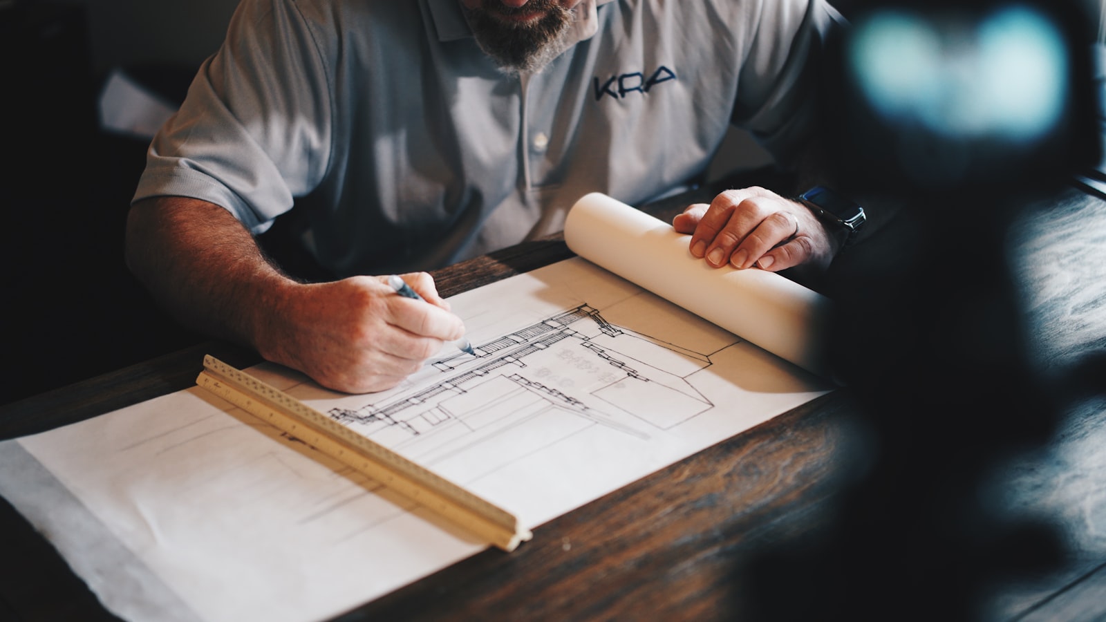Quantity surveyor reviewing construction drawings for cost control